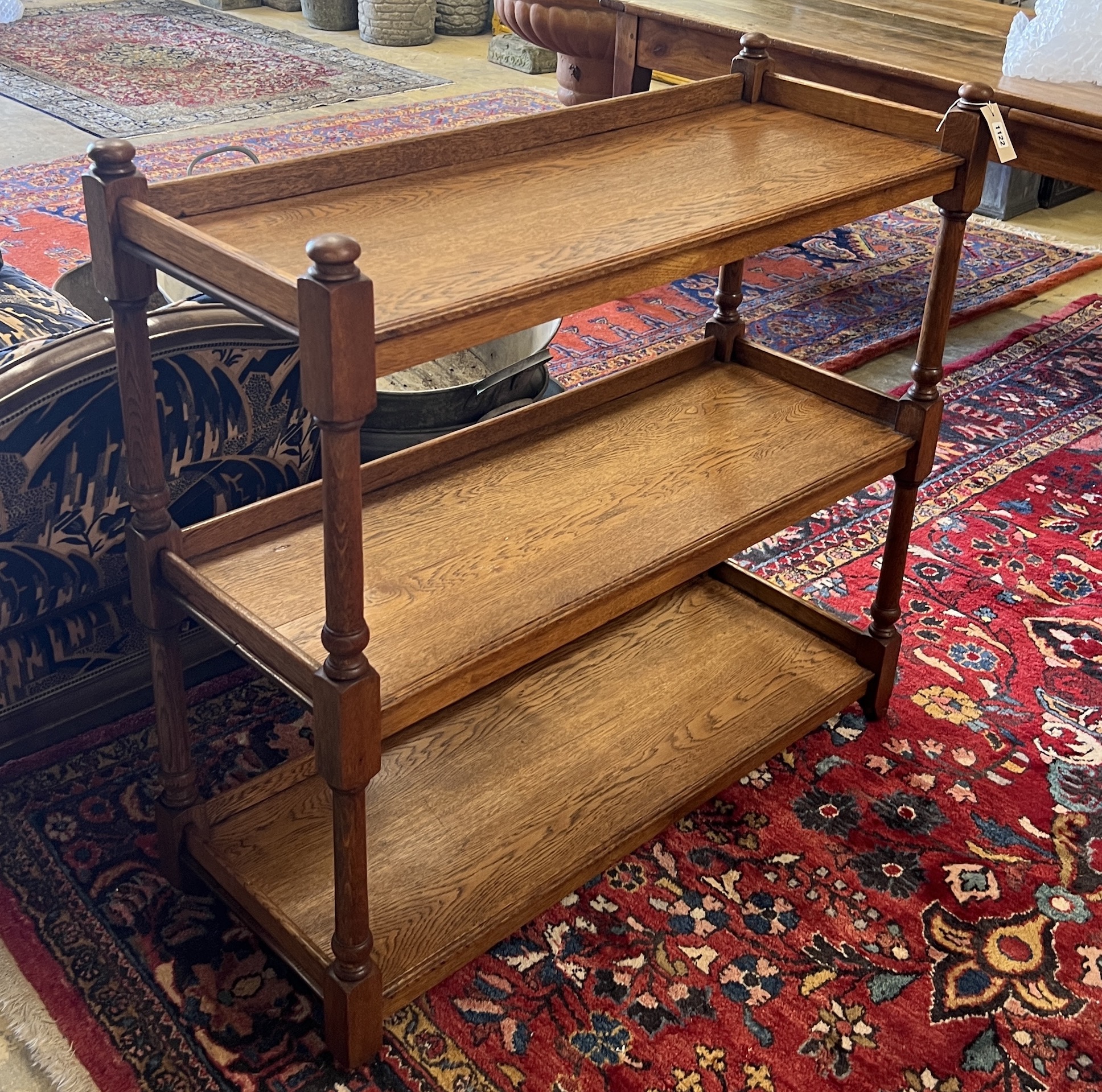 A late 19th / early 20th oak three tier buffet bears Jas Shoolbred & Co ivorine trade label, width 99cm, depth 38cm, height 95cm